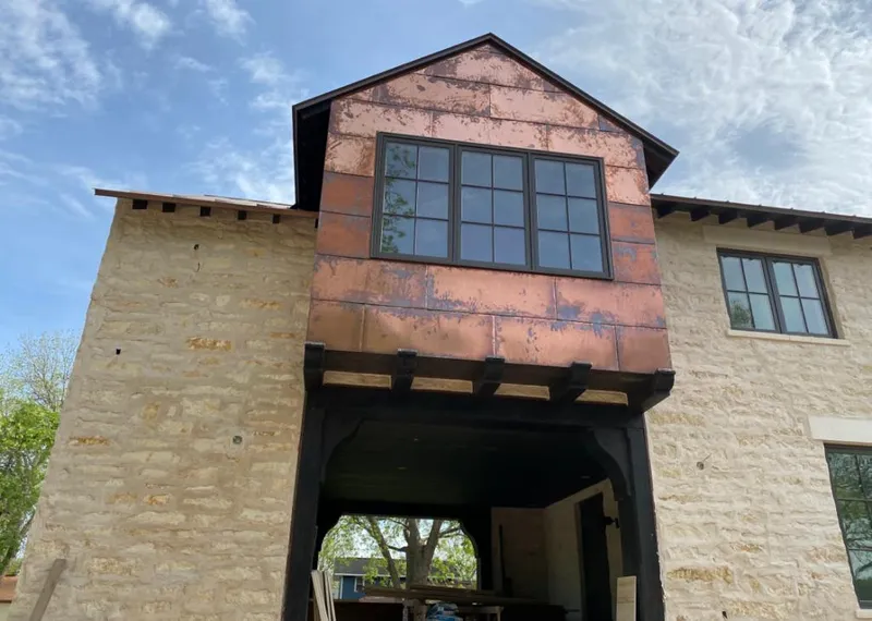 Copper metal panel facade on a stone building for Roof Repair in Rancho Mission Viejo